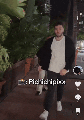 a man is walking down a sidewalk with the name pichichipixx on the bottom right
