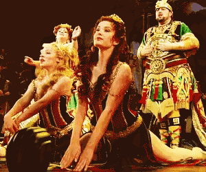 a group of people in costumes with one of them wearing a crown on her head