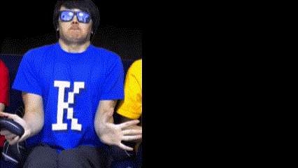 a man wearing sunglasses and a blue shirt with the letter k on it .
