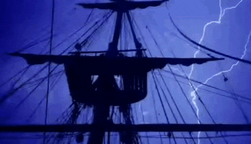 a pirate ship is silhouetted against a blue sky with lightning bolts .