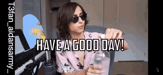 a man sitting in front of a piano with the words have a good day written above him