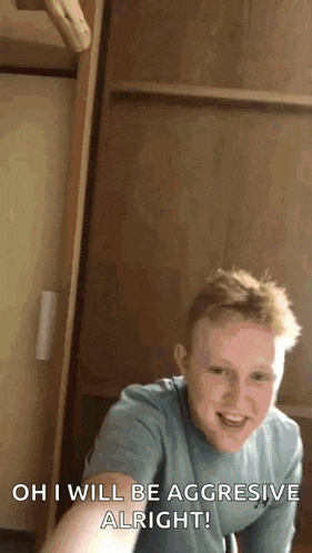 a young man is taking a selfie in front of a wooden wall and saying `` oh i will be aggressive alright ''