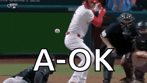 a baseball player is swinging at a ball with the word a-ok above him