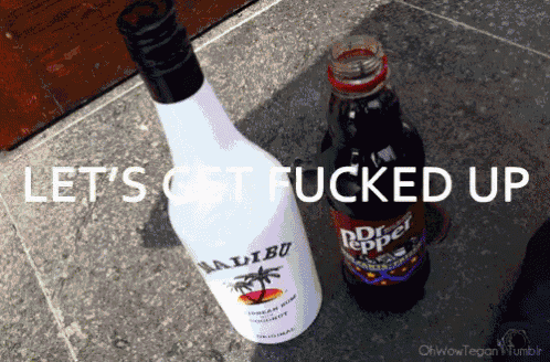 a bottle of malibu and a bottle of dr pepper are on the ground