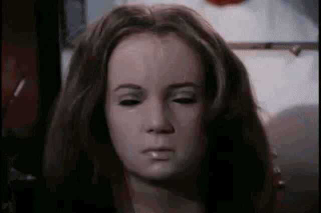 a close up of a woman 's face with a mask on .
