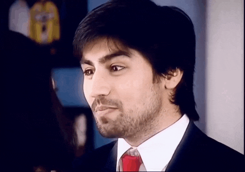a man with a beard wearing a suit and tie .