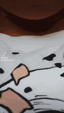 a close up of a person wearing a white shirt with a dalmatian on it