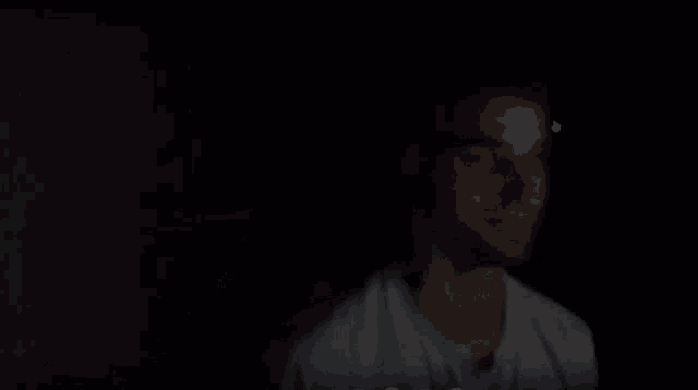 a blurry picture of a person 's face in a dark room