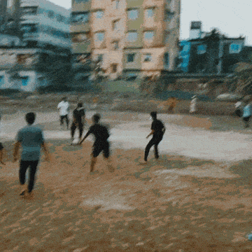 a group of people playing soccer in a field