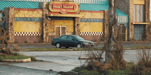 a car is parked in front of a freddy falcon 's restaurant
