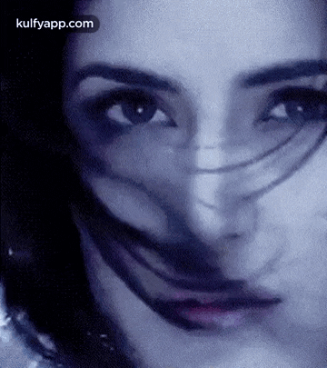 a close up of a woman 's face with a mask on it and a blurred background .