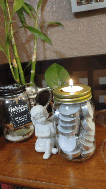 a candle in a jar with a sign that says wishing jar
