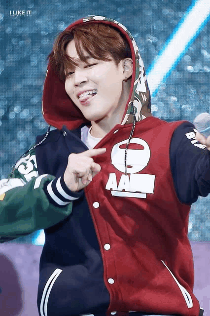 a man wearing a red jacket that says a bathing ape