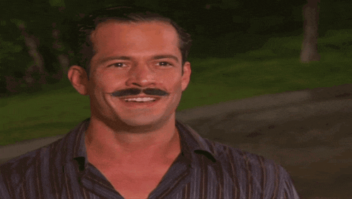 a man with a mustache has the name olivia written on his face