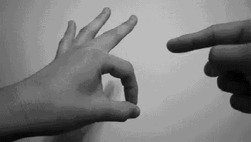 a black and white photo of a person making an ok sign with their fingers