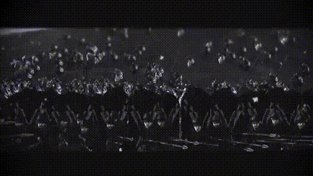a black and white photo of a large group of people riding horses