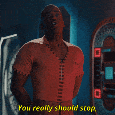 a man in a red shirt with the words you really should stop behind him