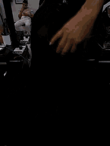 a person 's hand is visible in a blurry photo of their face .