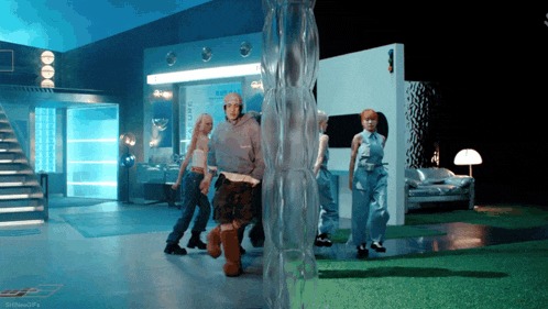a group of people are dancing in a room with a sign that says shiftedgifs