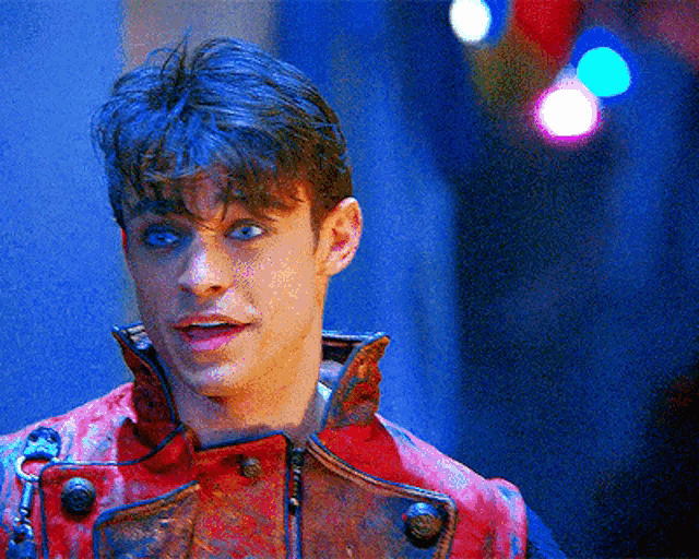 a close up of a man wearing a red jacket with buttons