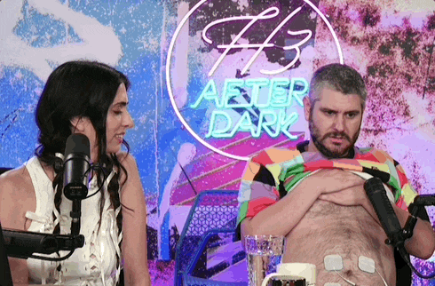 a man and a woman are in front of a sign that says after dark