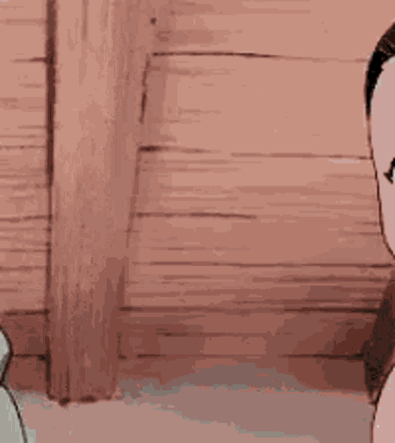 a cartoon cat with a sad face is sitting next to a man in a room .