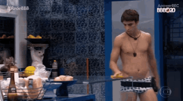 a man without a shirt is standing in front of a sign that says apowerrec bbb2020