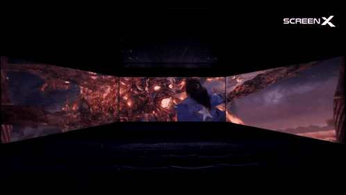 a dark room with a screen that says screenx