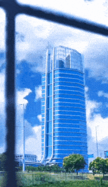 a very tall building with a lot of windows against a blue sky