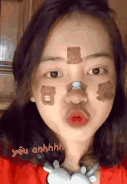 a girl with teddy bears painted on her face is making a funny face