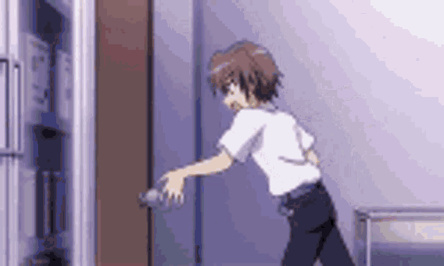 a boy is standing in front of a refrigerator door .