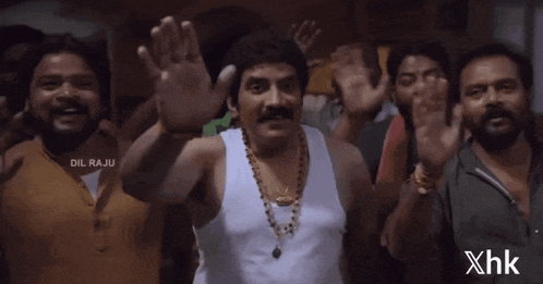 a group of men are waving their hands with the words dil raju written on the bottom