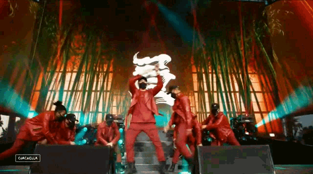 a man in a mask is dancing on a stage in front of a sign that says cancela