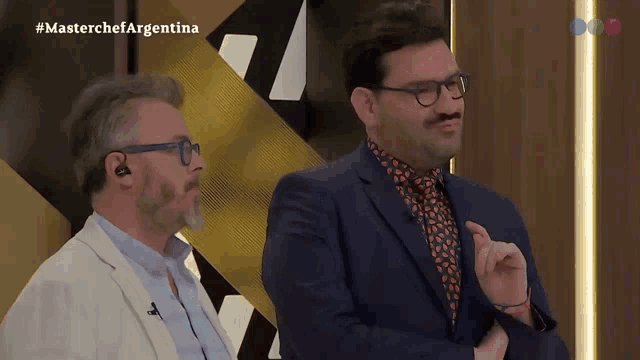 two men are on a television show called masterchef
