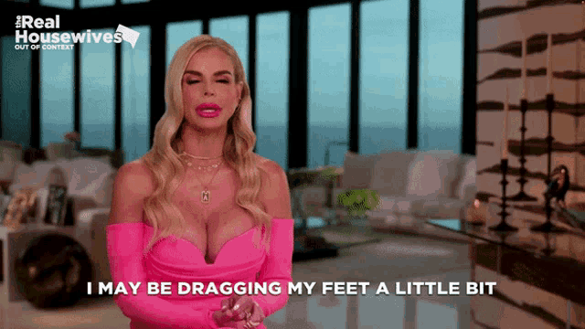 a woman in a pink dress with the words i may be dragging my feet a little bit