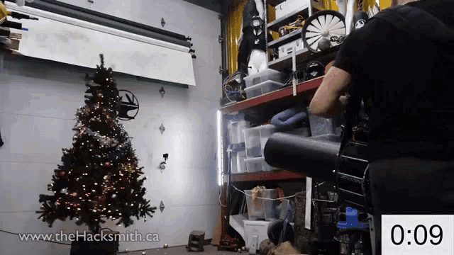 a christmas tree in a garage with the website www.thehacksmith.ca at the bottom of the screen