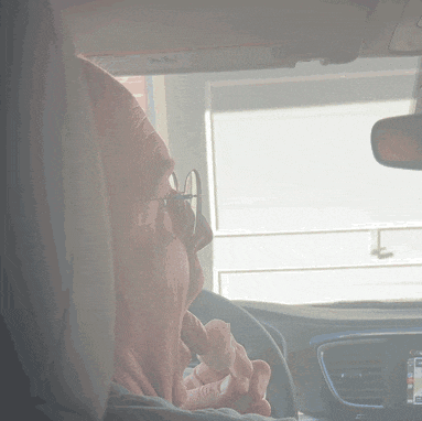 a person sitting in a car with a visor that says " airbag " on it