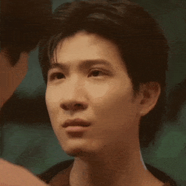 a close up of a man 's face with his eyes closed .