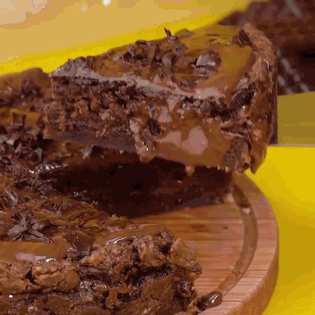 a piece of cake is being taken out of a cake on a cutting board