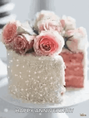 a cake with roses on top of it and the words `` happy anniversary '' .