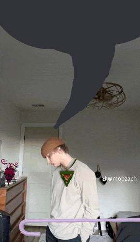 a man standing in a room with a tornado behind him and the name mobzach on the bottom