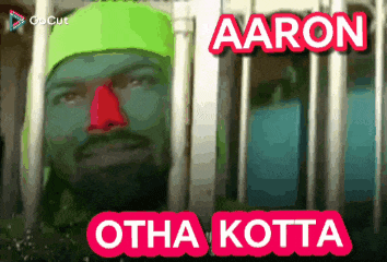 a man with green paint on his face and the name aaron