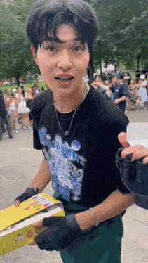 a man wearing a black shirt that says slow donuts