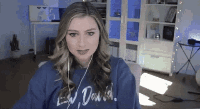 a woman wearing a blue sweatshirt with the word david on it .