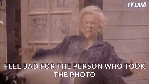 an elderly woman in a purple jacket is standing in front of a building and talking .