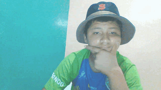 a young boy wearing a hat and a shirt that says bingo