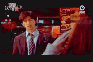 a man in a suit and tie is talking to a woman in a foreign language