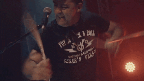 a man wearing a shirt that says punk & roll