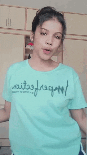 a girl wearing a t-shirt that says sails fragan on it