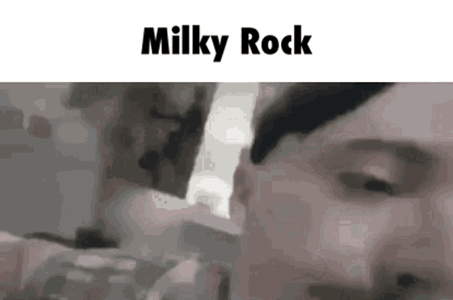 a close up of a person 's face with the words milky rock written on the bottom .